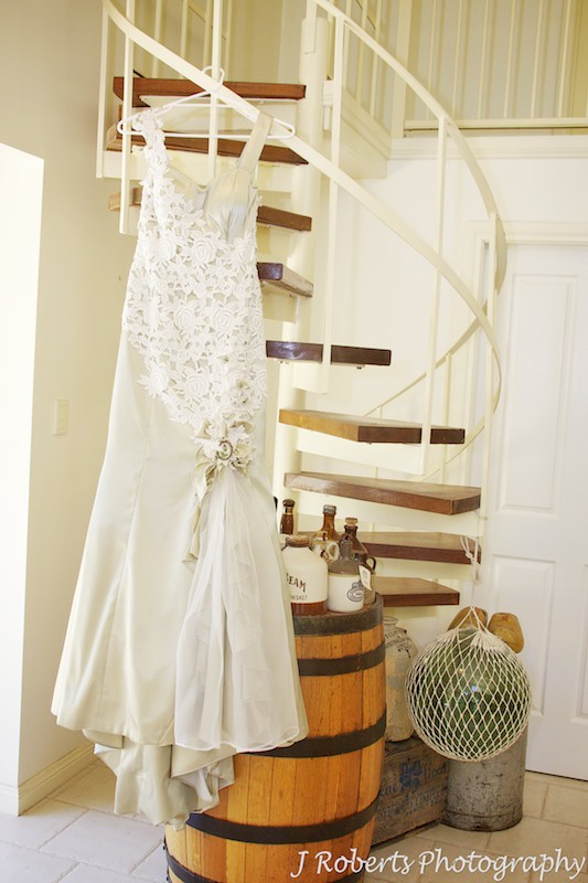 Wedding dress hanging from spiral staircase - wedding photography sydney